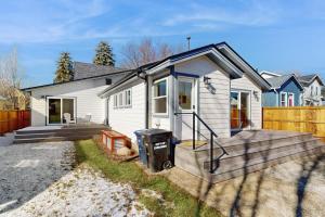 a small white house with a wooden deck at Library House in Durango
