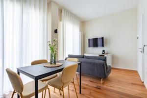 a living room with a table and chairs and a couch at Piccinni 133 in Bari