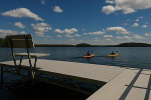 three people in kayaks on a dock on a lake at Katherine Lake Lodge in Hazelhurst +53 photos