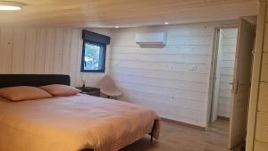 a bedroom with a large bed and a window at Chalet Ali Vue panoramique in Le Castellet