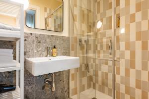 a bathroom with a sink and a shower at Piccinni 133 in Bari