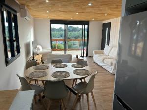a kitchen and living room with a table and chairs at Chalet Ali Vue panoramique in Le Castellet