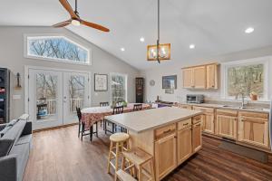 a kitchen with a table and a dining room at All Decked Up - wifi, view, river access, fire pit, 3 bedrooms, games, family friendly in Great Cacapon