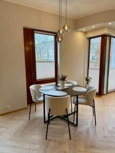 a dining room with a table and chairs at Vallikraavi Old Town Apartment in Tartu