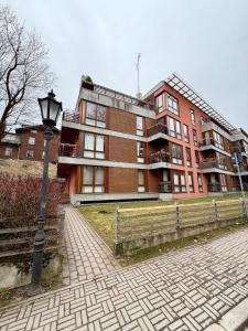 a building with a street light in front of it at Vallikraavi Old Town Apartment in Tartu