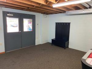 a room with a door and a chair in it at Lilly Pad Landing in Hazelhurst