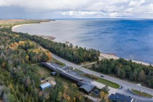 an aerial view of a train on a road next to the water at Manistique Sands in Manistique