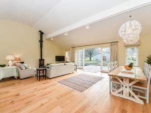 a living room with a table and a couch at Beaufort Dairy in Pulborough