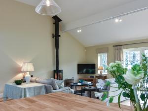 a living room with a couch and a table at Beaufort Dairy in Pulborough