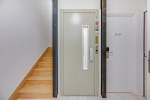 a hallway with a white door and a staircase at Correio Velho Hotel in Lisbon