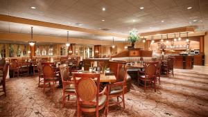 a restaurant with tables and chairs in a room at Eden Resort and Suites, BW Premier Collection in Lancaster