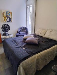 a bed with pillows on it in a room at Apartamento 3 quarto Alto Bueno in Goiânia