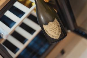 a bottle of wine is hanging on a rack at Golden Suite in Stornarella
