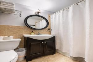 a bathroom with a sink and a mirror at Plush & Spacious 2-Bedroom in NYC in New York