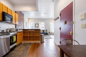 a kitchen with wooden cabinets and a counter top at Plush & Spacious 2-Bedroom in NYC in New York