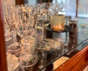 a group of wine glasses sitting on a glass table at Brandy Bay Hideaway: Pet Friendly Retreat in Arbor Vitae