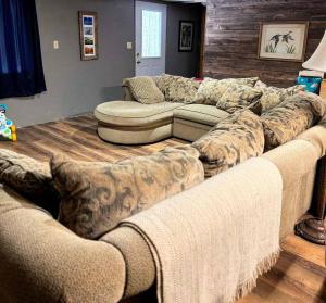 a living room with a large couches in a room at Brandy Bay Hideaway: Pet Friendly Retreat in Arbor Vitae