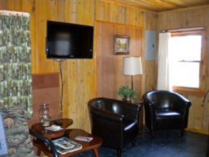 a living room with two chairs and a television at Old Stoney's Walleye- Pet Friendly in Arbor Vitae