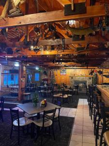 a dining room with tables and chairs and a fireplace at Gresham Shores - Big Dipper - PET FRIENDLY in Arbor Vitae