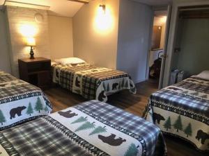 a hotel room with three beds with bears on them at Gresham Shores - Big Dipper - PET FRIENDLY in Arbor Vitae