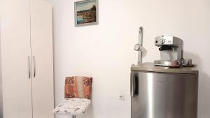 a silver refrigerator with a coffee maker on top of it at Stairway to heaven in Shkodër +6 photos