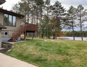a house with a wooden deck next to a lake at Lilly Pad Landing in Hazelhurst +29 photos