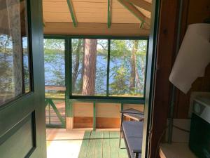 an inside view of a room with a window in a house at Gresham Shores - Lil' Sunfish - PET FRIENDLY in Arbor Vitae +15 photos