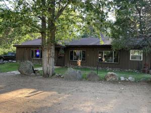 a brown house with rocks in front of it at Gresham Shores - Big Dipper - PET FRIENDLY in Arbor Vitae +20 photos