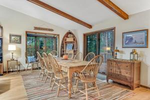 a dining room with a wooden table and chairs at Loonsight in Minocqua