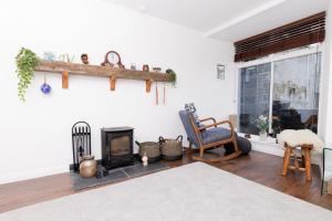 a living room with a fireplace and a stove at Bains Closs, Shetland Islands in Lerwick