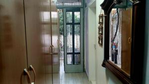 a hallway with a green door and a mirror at Stairway to Heaven in Shkodër