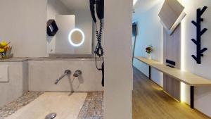 a living room with a phone on the wall at Boutique Hotel Adler in Golling an der Salzach +35 photos