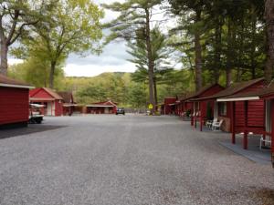 a street in a village with red buildings at Do-Rest Court in Lake George