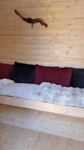 a bed made out of a wooden wall with clouds at Tonneau Bourgignon in Le Rousset +1 photo
