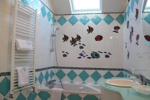 a bathroom with a shower and a sink and a tub at Le Relais de la Tour in La Chaussée-Saint-Victor +114 photos