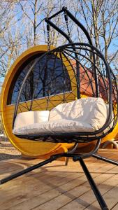 a swing sitting on top of a wooden deck at Tonneau Bourgignon in Le Rousset