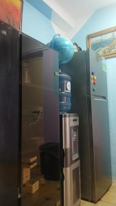 a refrigerator in a room with aperature at Stairway to heaven in Shkodër +9 photos