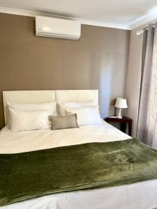 a bedroom with a large bed with two pillows at Luxurious 2Bed ,Iconic Views Mountain& Beach in Big Bay
