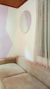 a living room with a couch and a mirror at Stairway to heaven in Shkodër