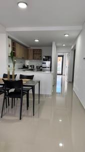 a kitchen and dining room with a table and chairs at Portal Patagónico in Puerto Madryn