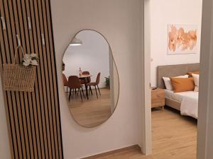 a mirror on a wall in a living room at Lo Spaho Suite Florence in Florence