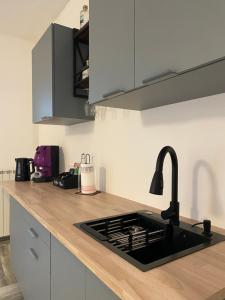a kitchen with a sink and a counter top at Amunì Guest House in Carini