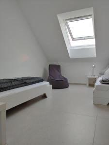 a white room with a bed and a window at Ferienwohnung Hagebutte in Bad Bocklet