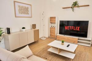 a living room with a tv and a couch at Ortensie House in Padova