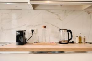 a kitchen counter with a coffee maker and a toaster at Ortensie House in Padova +26 photos