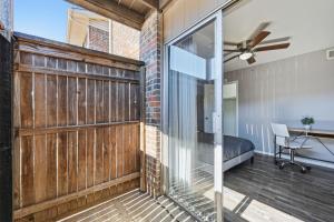 a room with a sliding barn door and a bedroom at Great 1BR Mid-Term Apartment in Denton
