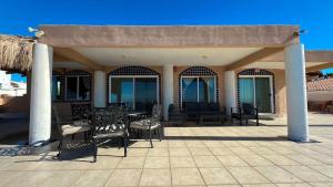 a pavilion with chairs and a table on a patio at Recently Updated Beachfront Home Casa Neblina in Puerto Peñasco