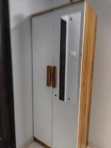 a white cabinet with a television on top of it at Rahatani pimple Saudagar 2bhk in Chinchwad +5 photos