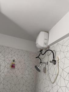 a bathroom with a tennis racket hanging on the wall at Rahatani pimple Saudagar 2bhk in Chinchwad