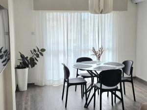 a dining room with a table and chairs at Beach apartments in Limassol